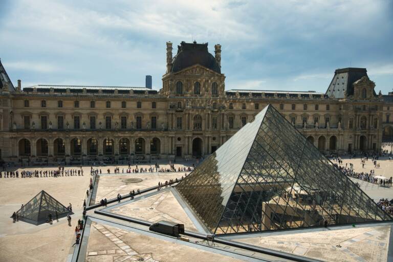 The louvre museum with its famous glass pyramid.